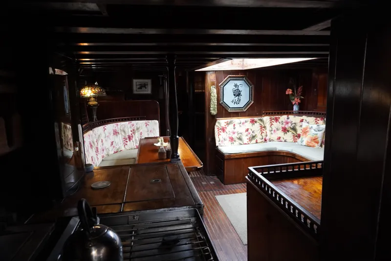 Slide: The Image of Interior of a 1976 Manila Shipbuilders sailboat with floral upholstery and wooden furnishings. - 8