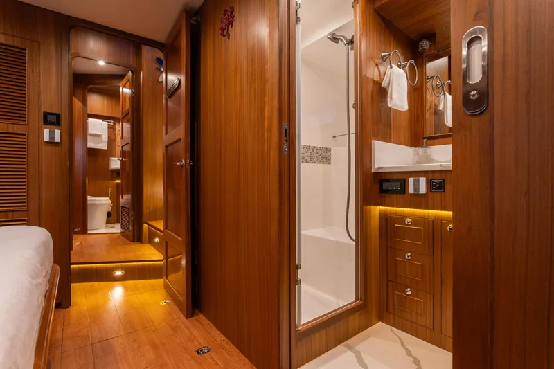 Slide: The Image of Luxurious 2021 North Pacific 49 Pilothouse interior with wood finish and modern bathroom amenities. - 10