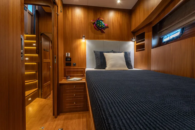 Slide: The Image of Luxurious cabin interior of 2021 North Pacific 49 Pilothouse yacht with wooden finish. - 11