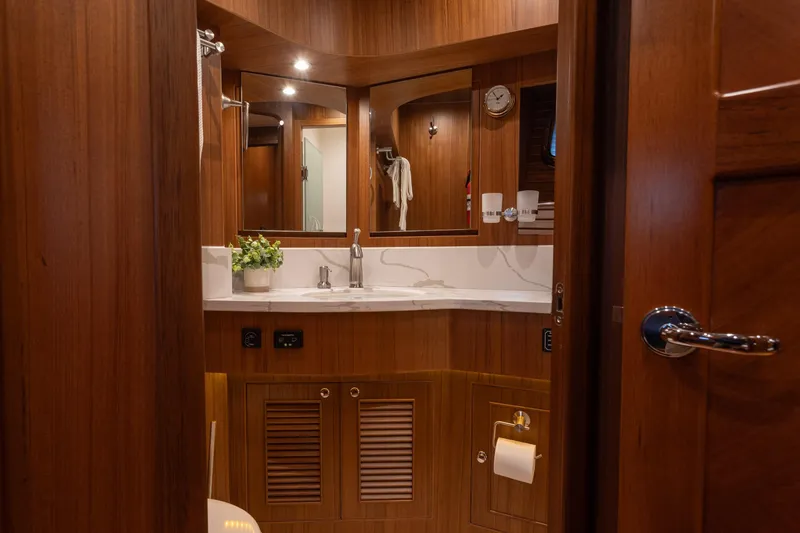 Slide: The Image of Luxurious bathroom interior of 2021 North Pacific 49 Pilothouse yacht with wooden finish. - 12