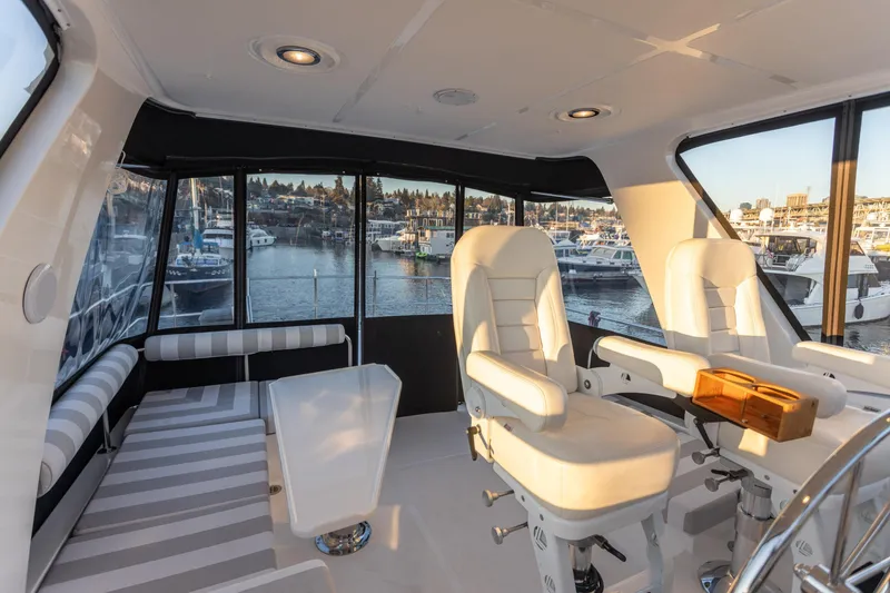Slide: The Image of Luxurious interior of 2021 North Pacific 49 Pilothouse yacht with marina view. - 16