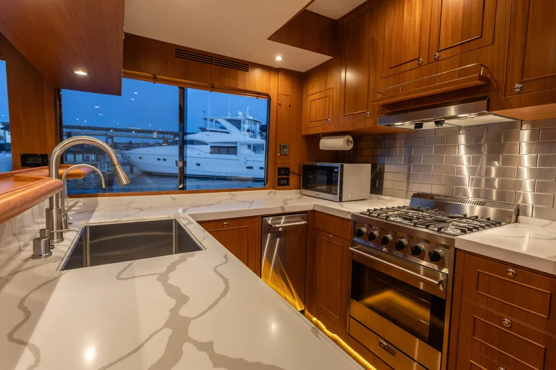 Slide: The Image of Luxurious kitchen interior of 2021 North Pacific 49 Pilothouse yacht with modern appliances. - 2