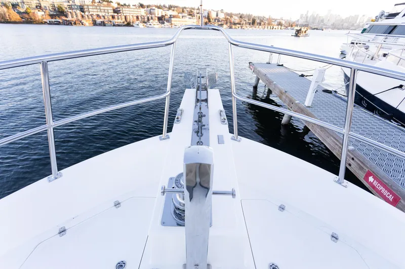 Slide: The Image of Bow view of 2021 North Pacific 49 Pilothouse yacht docked at marina. - 23