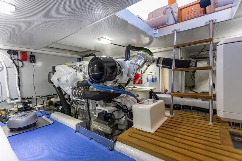 Slide: The Image of Engine room of 2021 North Pacific 49 Pilothouse yacht, featuring modern equipment and ladder access. - 29