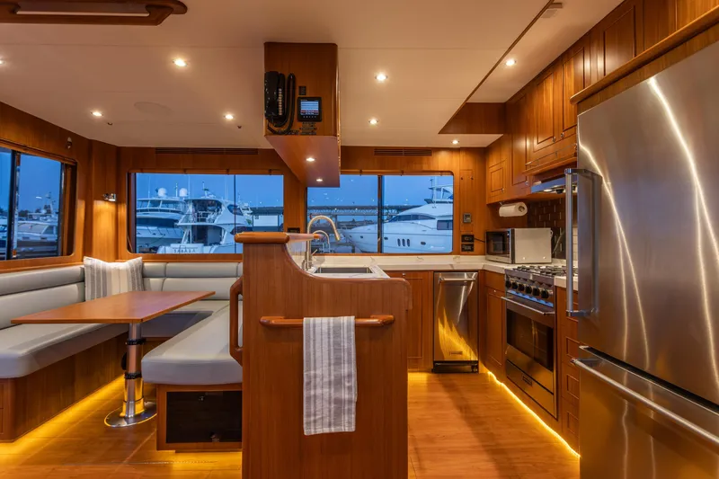 Slide: The Image of Luxurious 2021 North Pacific 49 Pilothouse interior with modern kitchen and dining area. - 3
