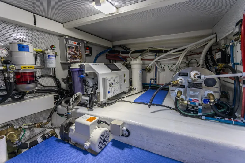 Slide: The Image of Engine room of 2021 North Pacific 49 Pilothouse with mechanical equipment and wiring. - 30