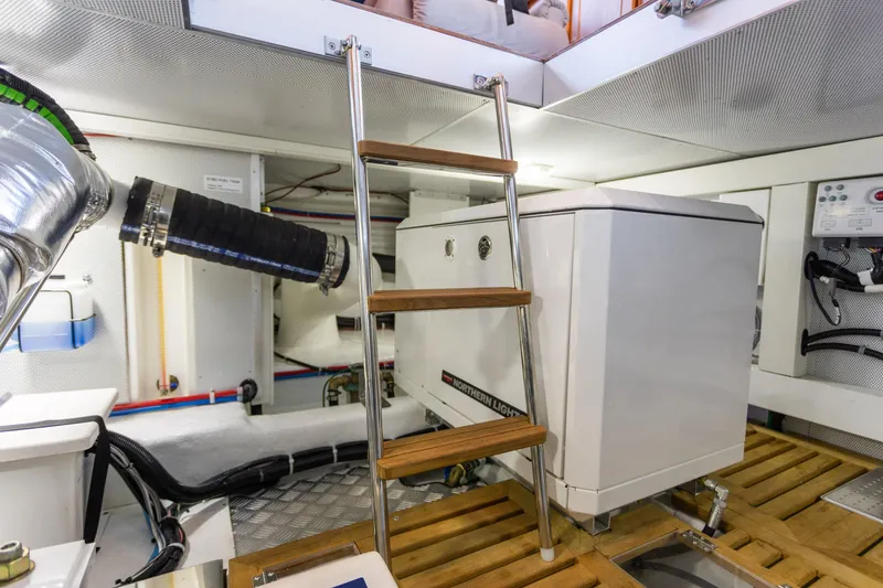 Slide: The Image of Engine room of 2021 North Pacific 49 Pilothouse yacht with ladder and equipment. - 32