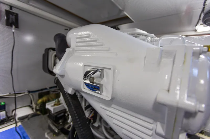 Slide: The Image of Engine room of 2021 North Pacific 49 Pilothouse featuring Cummins engine. - 33