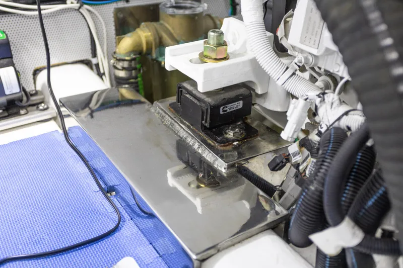 Slide: The Image of Engine room of 2021 North Pacific 49 Pilothouse with mechanical components and wiring. - 34