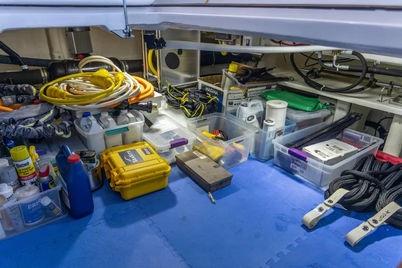 Slide: The Image of Organized storage area in 2021 North Pacific 49 Pilothouse with tools and supplies. - 35