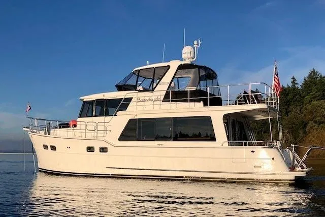 Slide: The Image of 2021 North Pacific 49 Pilothouse yacht on calm water, clear sky background. - 40