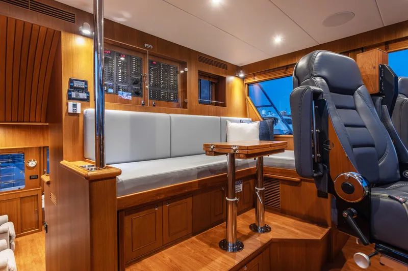 Slide: The Image of Luxurious interior of 2021 North Pacific 49 Pilothouse with plush seating and control panel. - 6