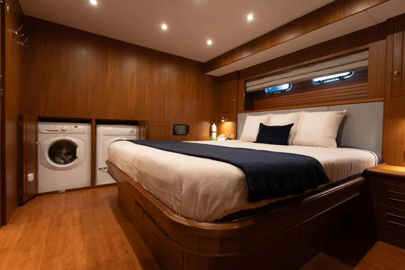 Slide: The Image of Luxurious bedroom in 2021 North Pacific 49 Pilothouse yacht with washer and dryer. - 8