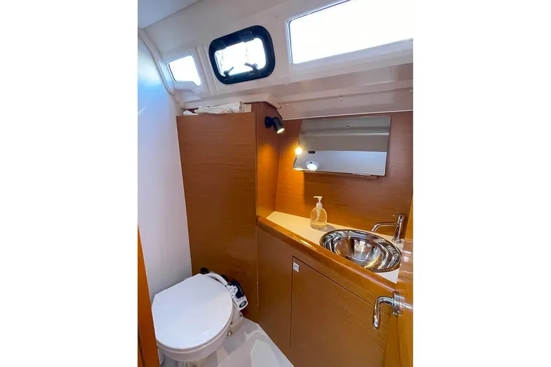 Slide: The Image of 2017 Jeanneau Sun Odyssey 349 bathroom with sink, mirror, and toilet. - 10
