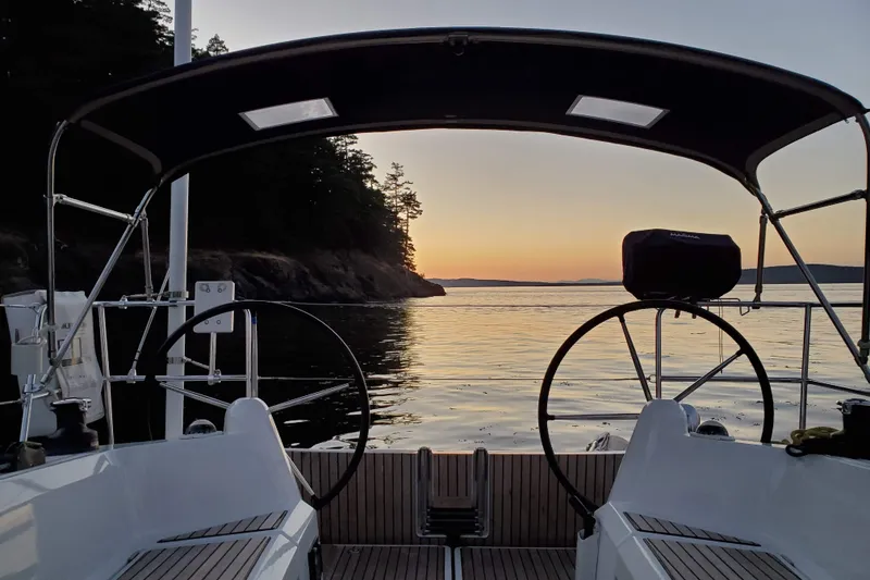 Slide: The Image of 2017 Jeanneau Sun Odyssey 349 sailboat at sunset, serene coastal view. - 13