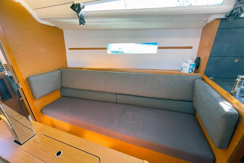 Slide: The Image of Interior of 2017 Jeanneau Sun Odyssey 349 sailboat with gray cushioned seating. - 5