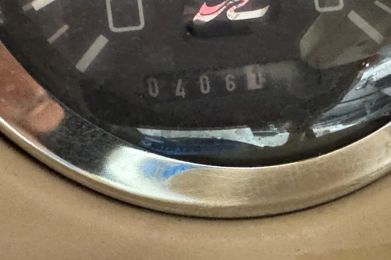 Slide: The Image of Close-up of a 1998 Sea Ray 240 Sundeck gauge displaying 406 hours. - 12