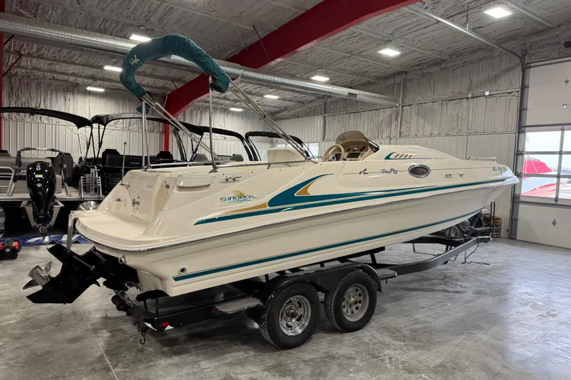 Slide: The Image of 1998 Sea Ray 240 Sundeck boat on trailer in indoor storage facility. - 3