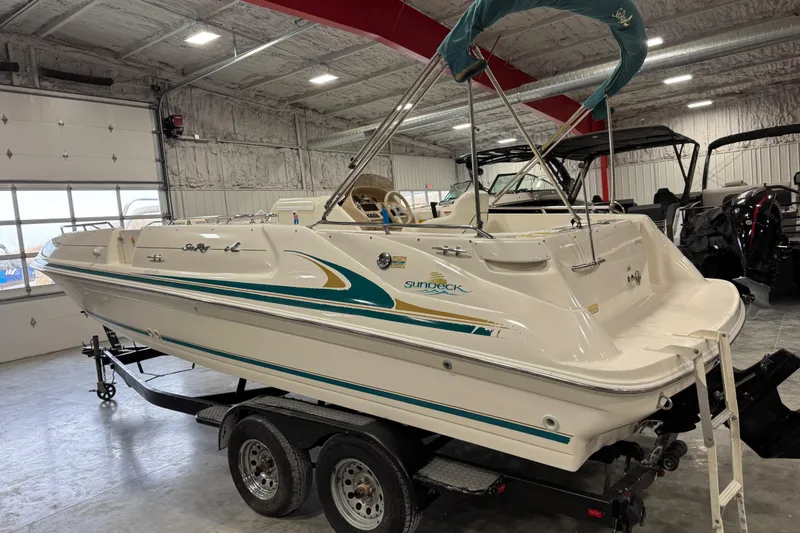Slide: The Image of 1998 Sea Ray 240 Sundeck boat on trailer in indoor storage facility. - 4