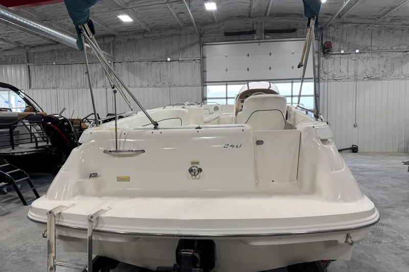 Slide: The Image of 1998 Sea Ray 240 Sundeck boat in a garage, rear view with open interior. - 5