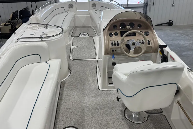 Slide: The Image of 1998 Sea Ray 240 Sundeck interior with helm, seating, and dashboard controls. - 7