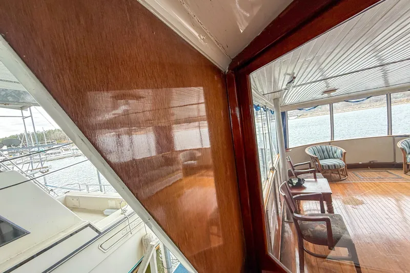 Slide: The Image of 1956 Burger Pilothouse yacht interior with wooden paneling and seating area. - 11