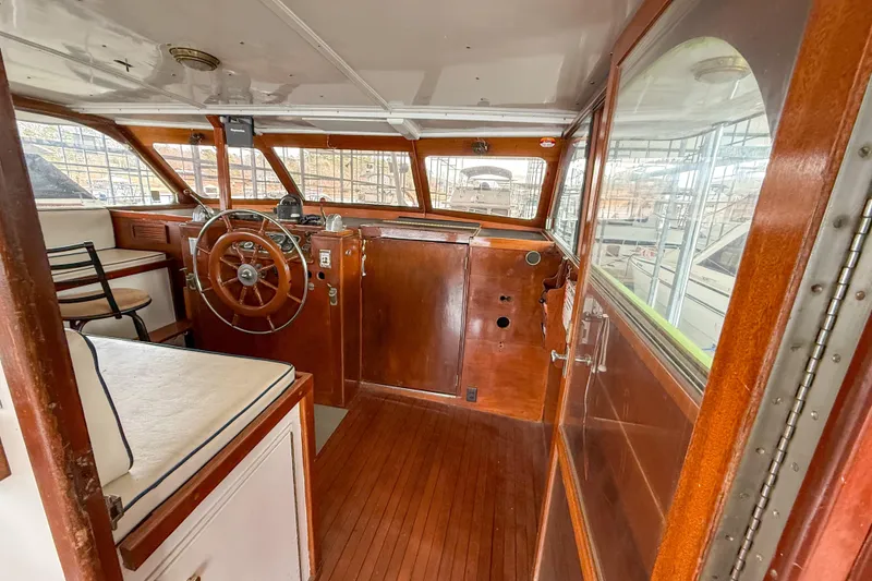 Slide: The Image of 1956 Burger Pilothouse interior with wooden steering wheel and classic design elements. - 23