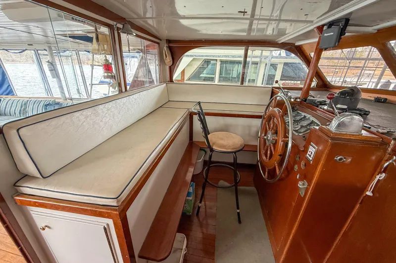 Slide: The Image of 1956 Burger Pilothouse interior with wooden helm, cushioned seating, and classic nautical design. - 25