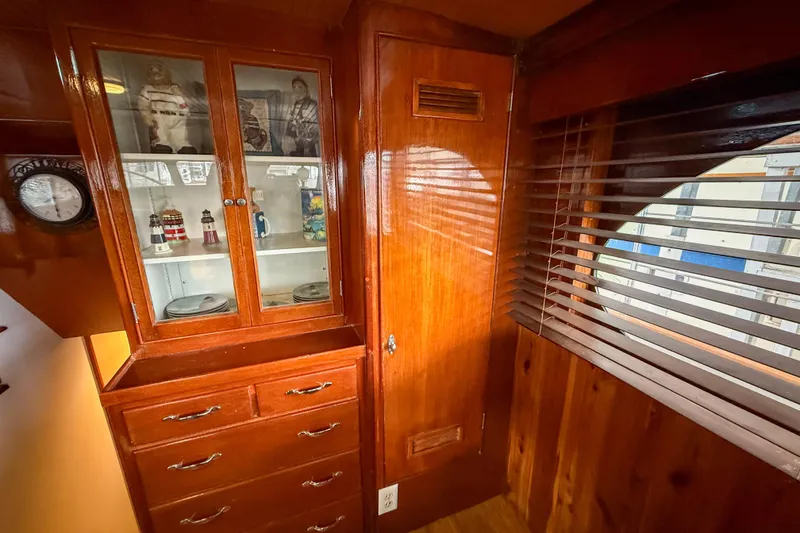 Slide: The Image of 1956 Burger Pilothouse interior with wooden cabinetry and nautical decor. - 29