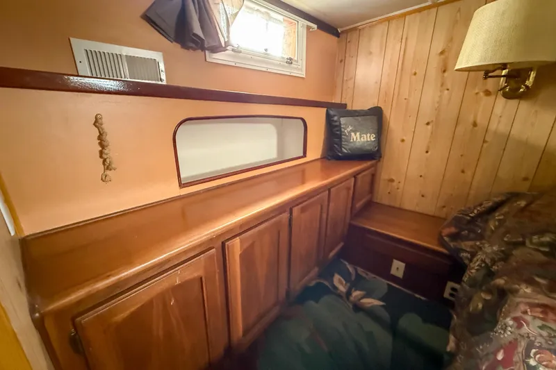 Slide: The Image of Cozy 1956 Burger Pilothouse interior with wood paneling and storage cabinets. - 38