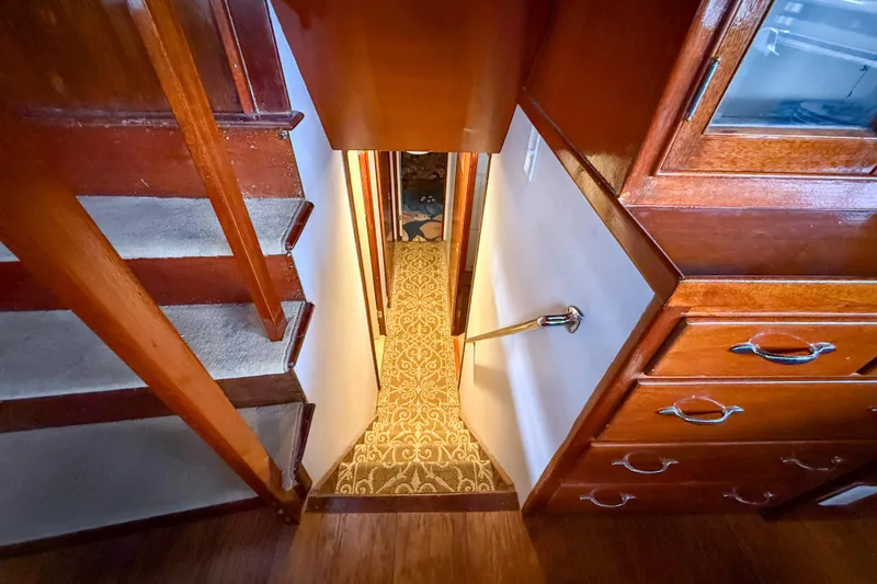 Slide: The Image of Staircase and hallway inside a 1956 Burger Pilothouse yacht with wooden cabinetry. - 40