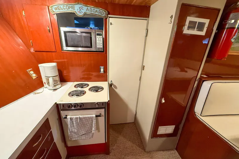 Slide: The Image of Vintage 1956 Burger Pilothouse kitchen with stove, microwave, and coffee maker. - 42