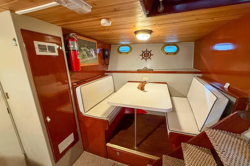 Slide: The Image of 1956 Burger Pilothouse interior with cozy dining nook, wooden ceiling, and nautical decor. - 43