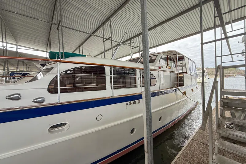 Slide: The Image of 1956 Burger Pilothouse yacht docked under a covered marina. - 5