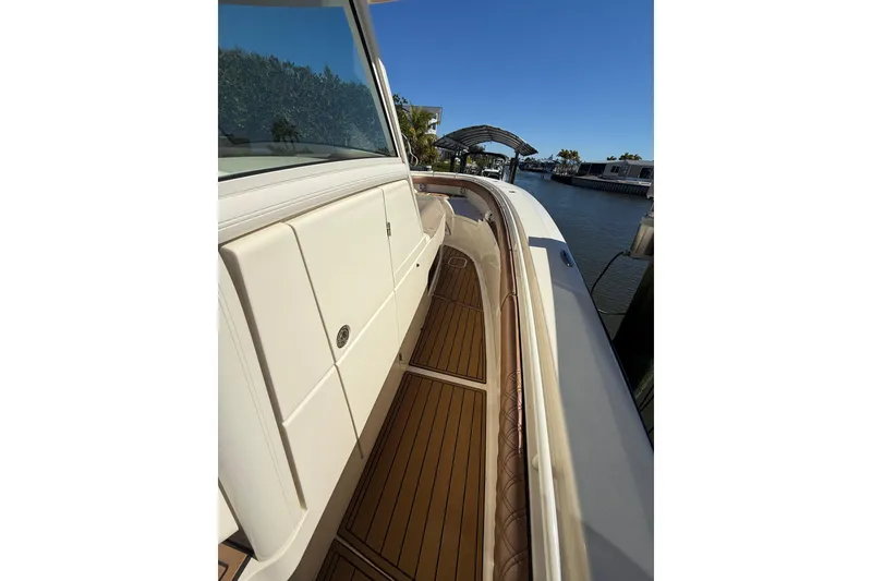 Slide: The Image of 2018 Scout 350 LXF boat deck with sleek design and wooden flooring. - 11