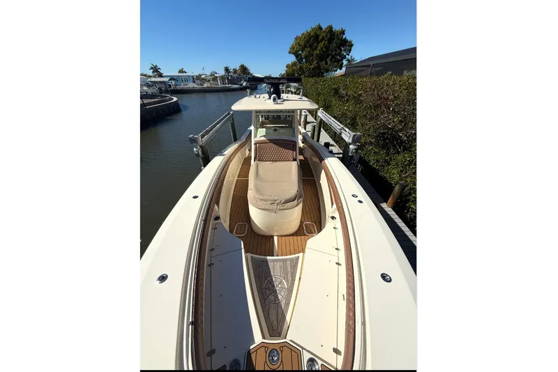 Slide: The Image of 2018 Scout 350 LXF boat docked in a sunny marina setting. - 13