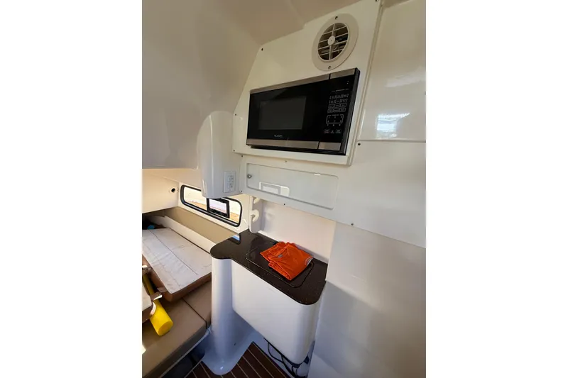 Slide: The Image of 2018 Scout 350 LXF cabin interior with microwave and seating area. - 17