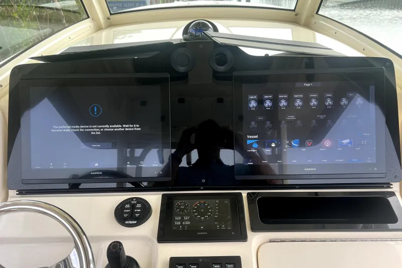 Slide: The Image of Control panel of a 2018 Scout 350 LXF boat with dual Garmin displays. - 18