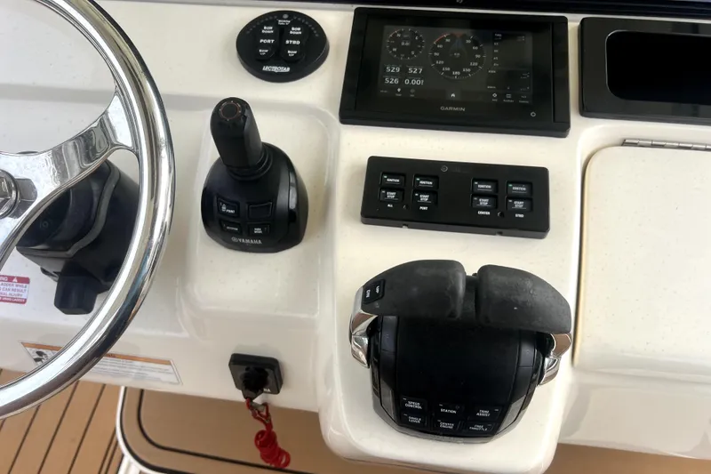 Slide: The Image of 2018 Scout 350 LXF boat dashboard with Garmin display and Yamaha controls. - 19