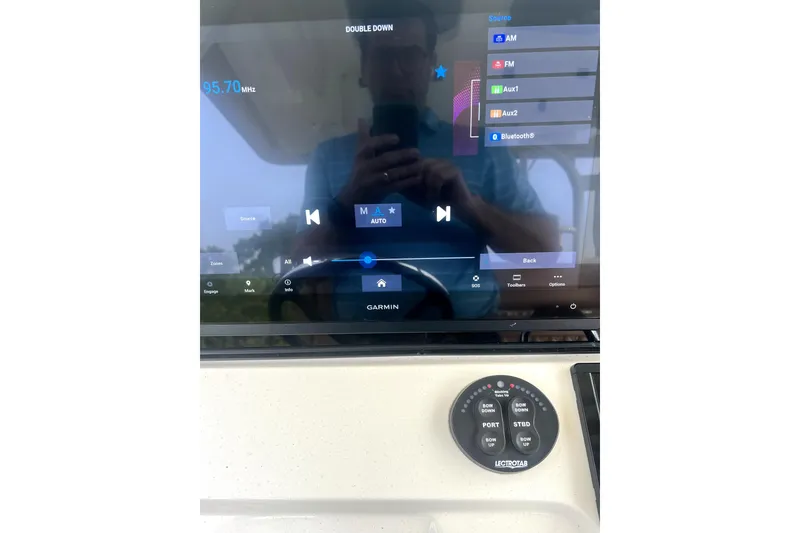 Slide: The Image of 2018 Scout 350 LXF boat dashboard with Garmin display and audio controls. - 26