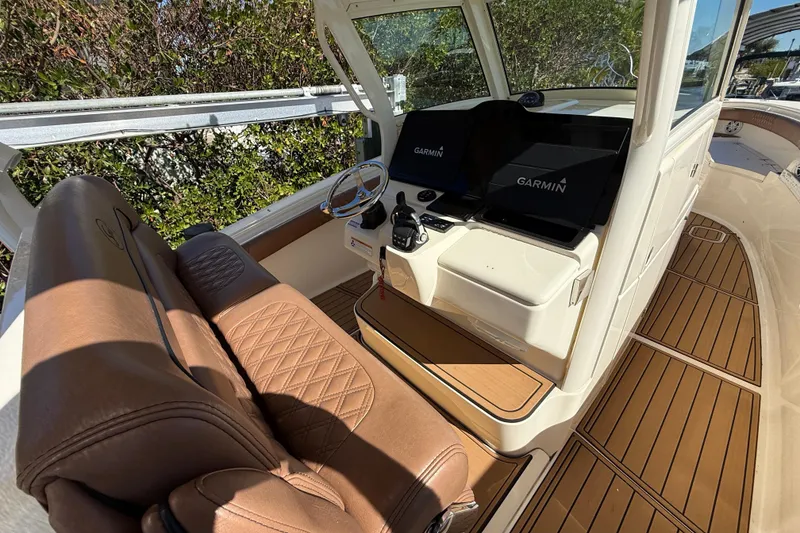 Slide: The Image of 2018 Scout 350 LXF boat interior with Garmin navigation system and luxurious seating. - 5