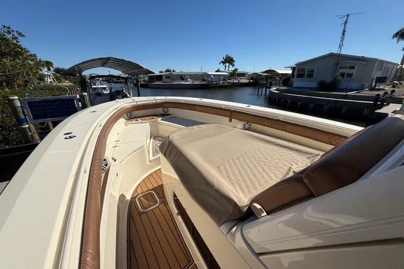 Slide: The Image of 2018 Scout 350 LXF boat docked in a sunny marina setting. - 7