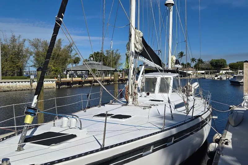 The Image of 1982 Tayana Center Cockpit Cutter Ketch docked in a sunny marina. - 0