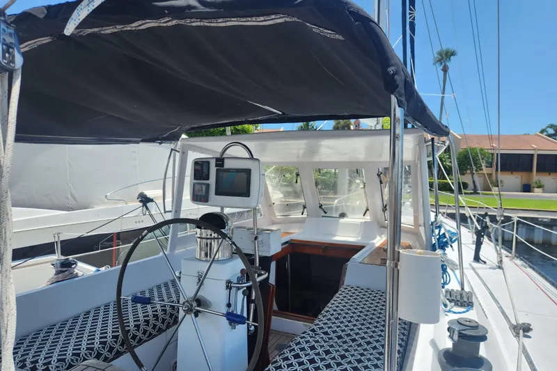 Slide: The Image of 1982 Tayana Center Cockpit Cutter Ketch with steering wheel and navigation equipment. - 12