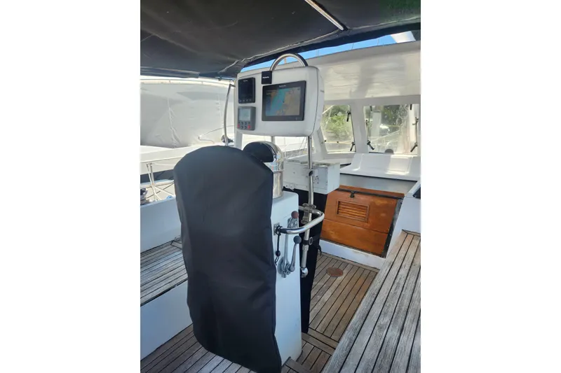 Slide: The Image of 1982 Tayana Center Cockpit Cutter Ketch helm with navigation equipment and wooden deck. - 13