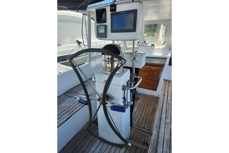 Slide: The Image of 1982 Tayana Center Cockpit Cutter Ketch helm with navigation equipment and wooden deck. - 14