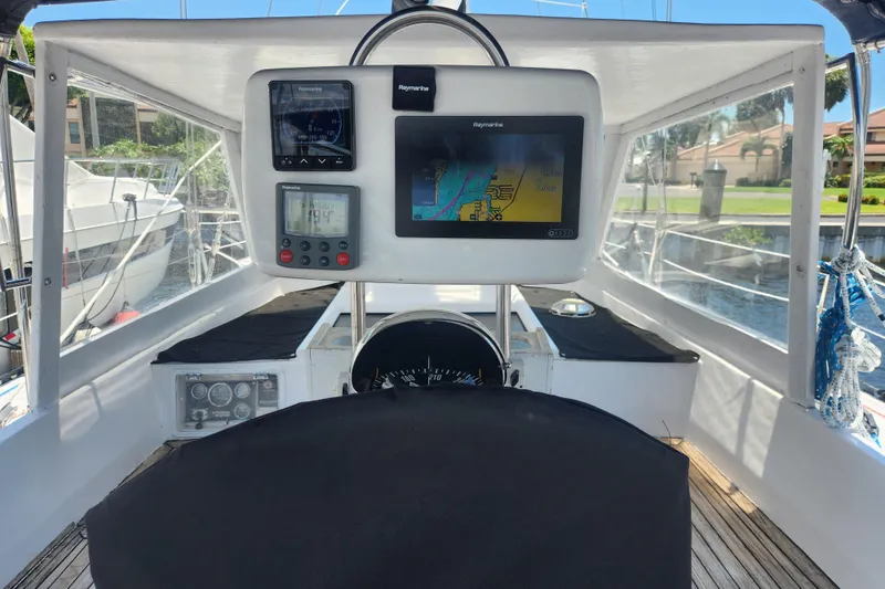 Slide: The Image of 1982 Tayana Center Cockpit Cutter Ketch helm with navigation instruments and chart display. - 16