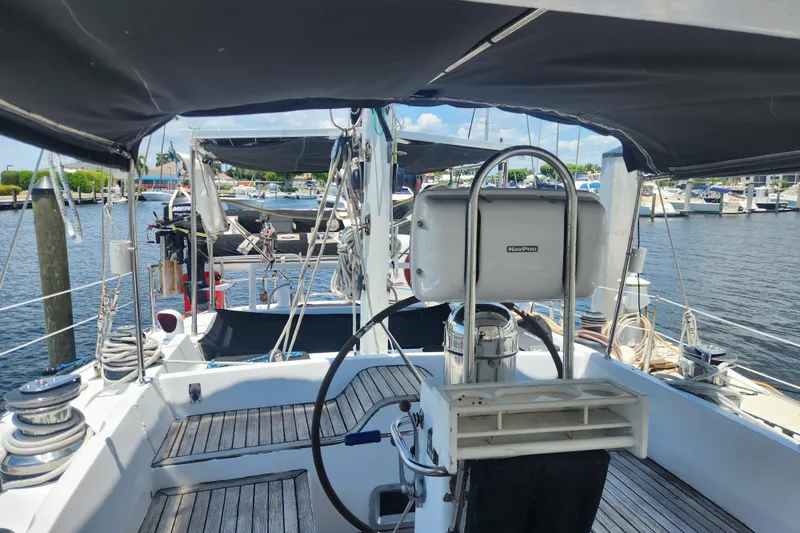 Slide: The Image of 1982 Tayana Center Cockpit Cutter Ketch with wooden deck, docked at marina. - 18