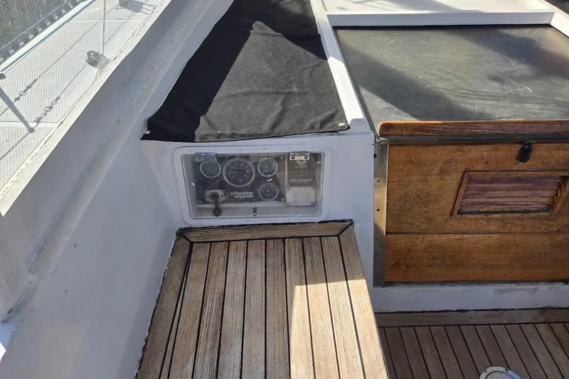 Slide: The Image of 1982 Tayana Center Cockpit Cutter Ketch interior with wooden flooring and instrument panel. - 22