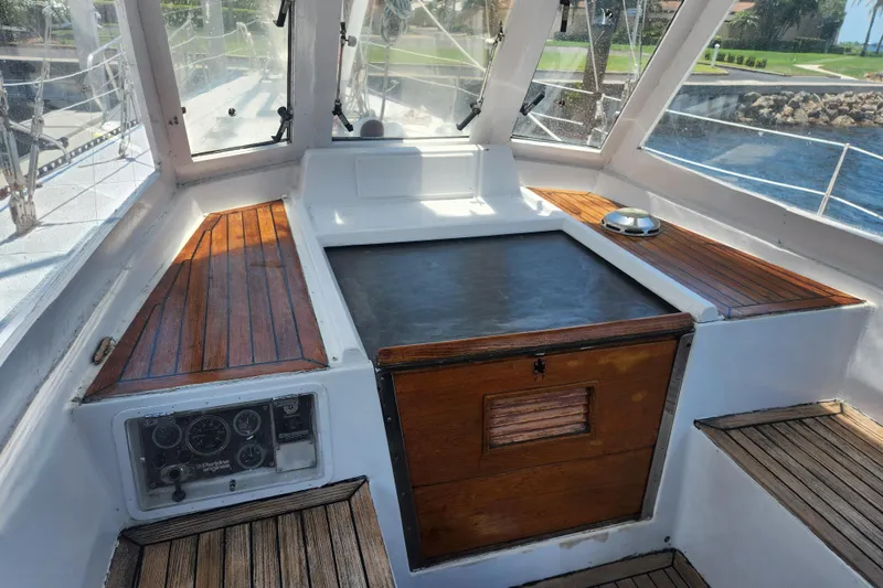 Slide: The Image of 1982 Tayana Center Cockpit Cutter Ketch interior with wooden accents and navigation instruments. - 23